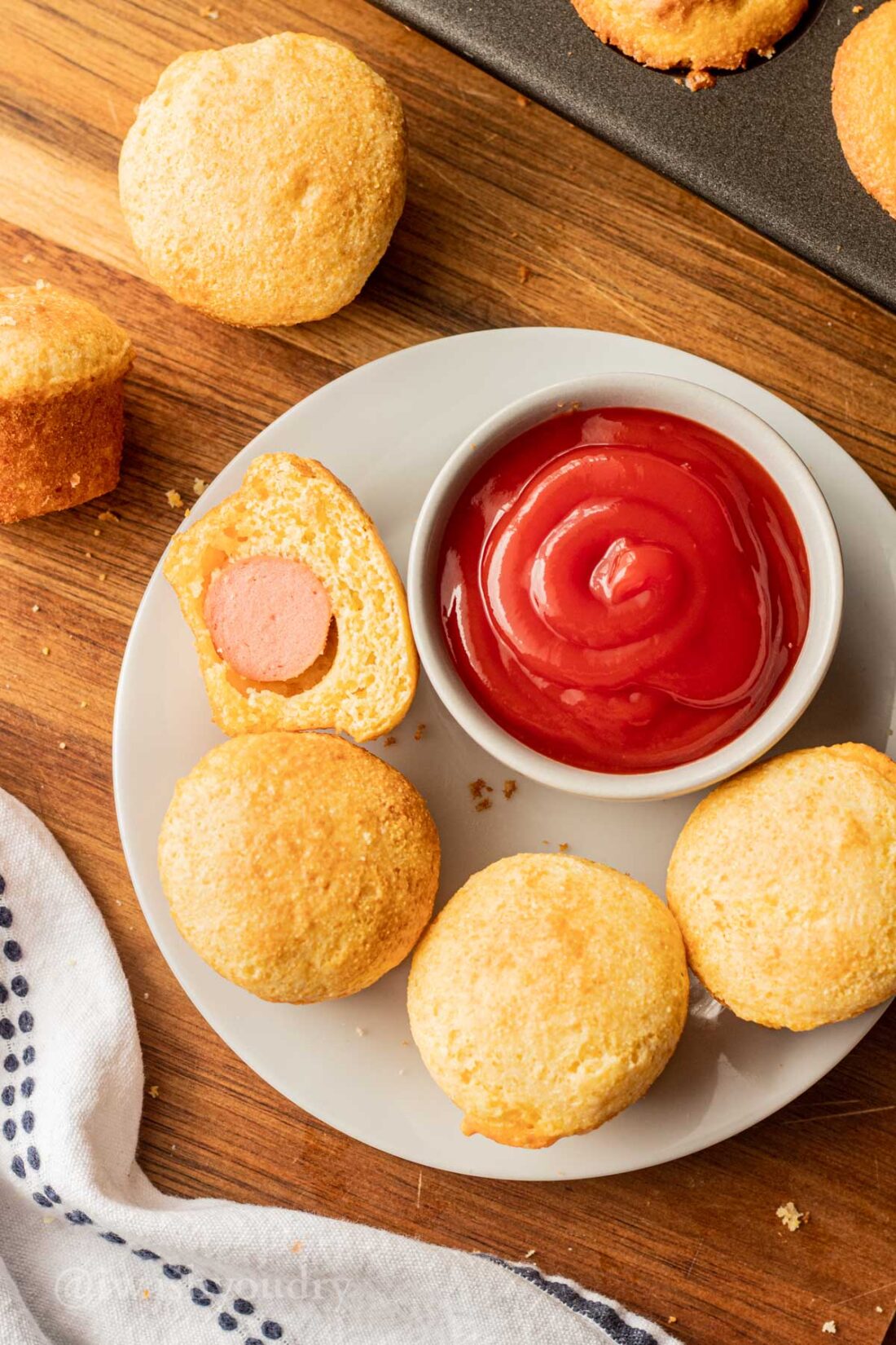 Mini Corn Dog Nuggets on a plate with a bowl of ketchup.