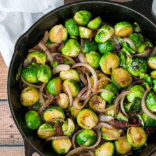 Render the bacon until it's almost crisp, then cook the Brussels Sprouts and onions in the bacon grease until they are caramelized and tender.