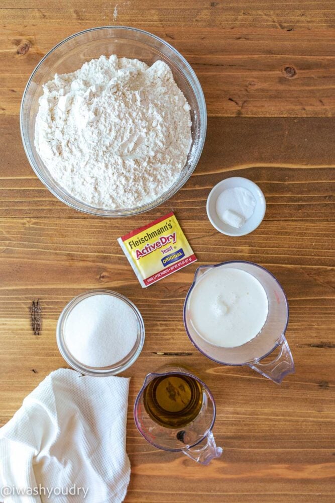 ingredients for cinnamon rolls on wooden surface.