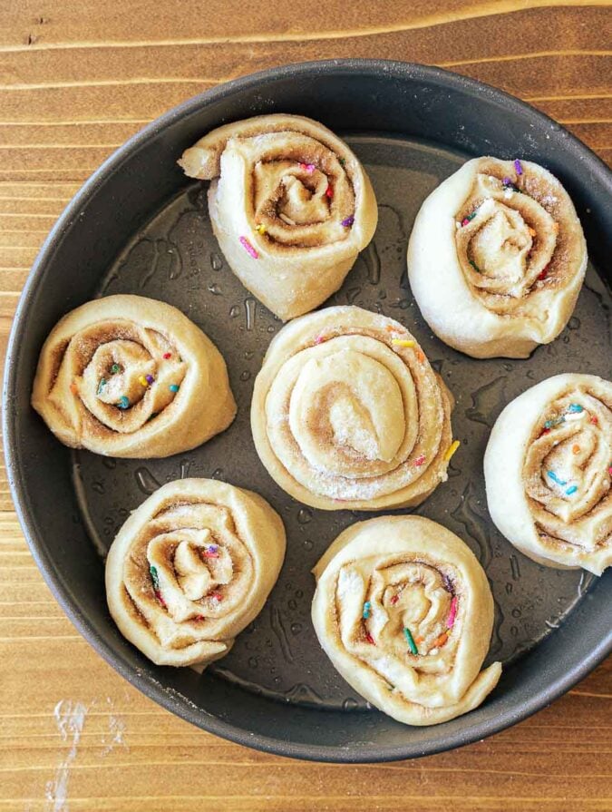 cinnamon rolls in baking dish before rising.