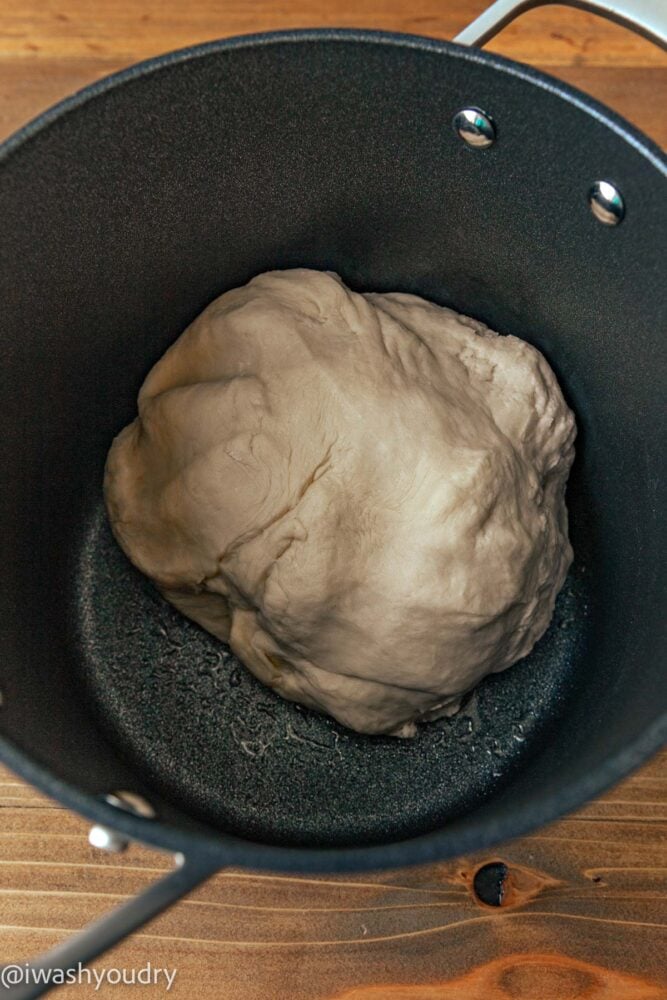 dough ball in black pot.