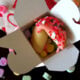 A Valentine Fortune Cookie displayed in a gift box with candied hearts