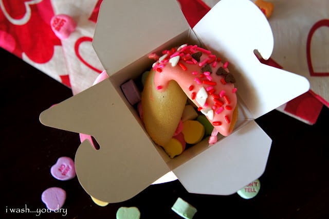 A Valentine Fortune Cookie displayed in a gift box with candied hearts