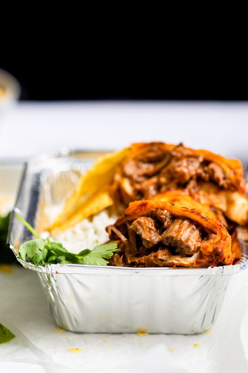 burrito with beef in foil plate.