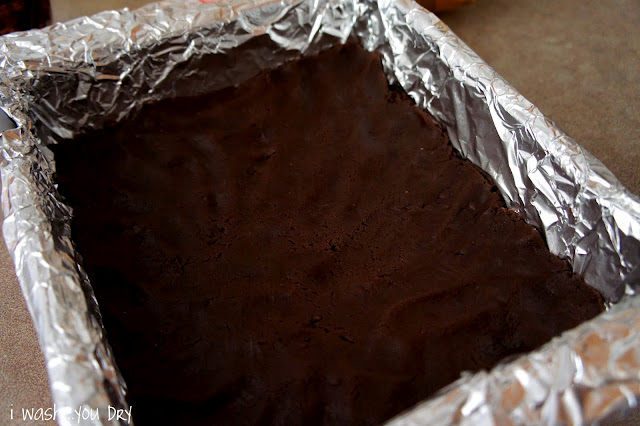 Chocolate dough pressed into the bottom of tin foil lined pan
