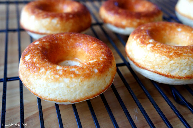 A close up of baked donuts on a cooling rack