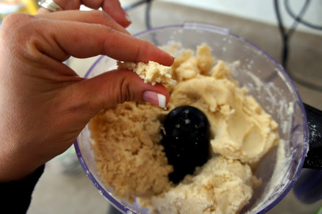 The pie dough should be able to hold together when lightly pinched.