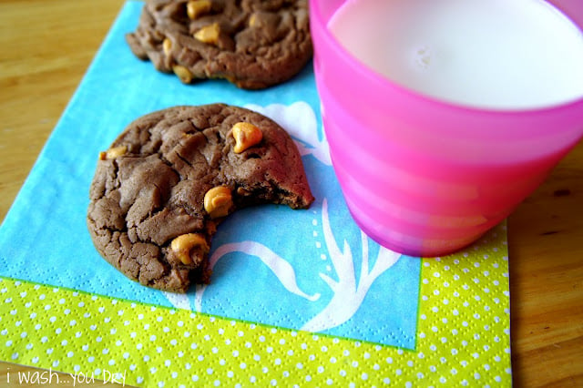 A couple cookies next to a glass of milk