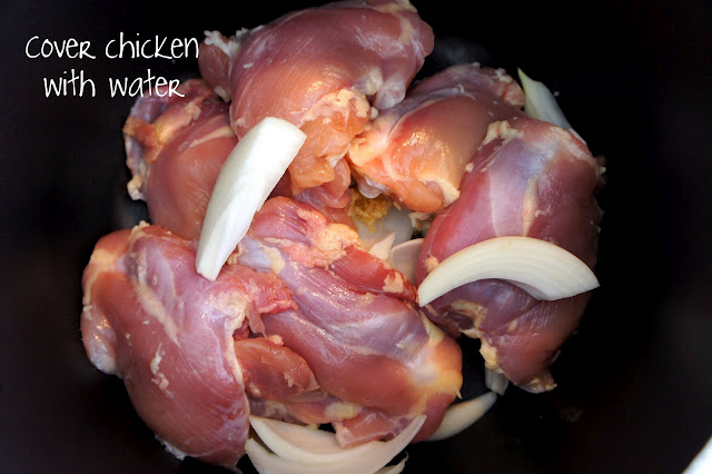 Raw chicken and onions in a crockpot
