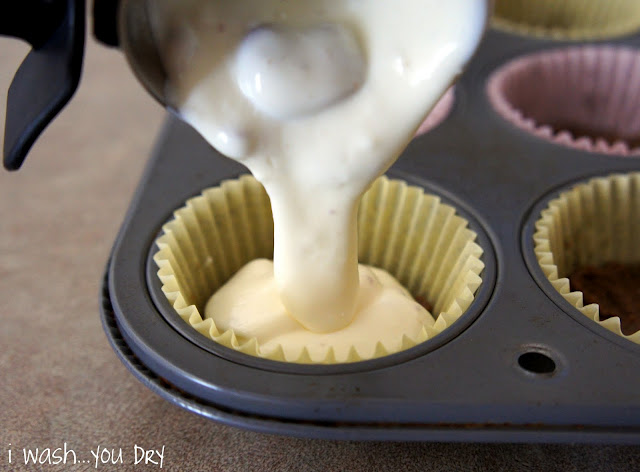 Cheesecake batter being poured into a cupcake wrapper