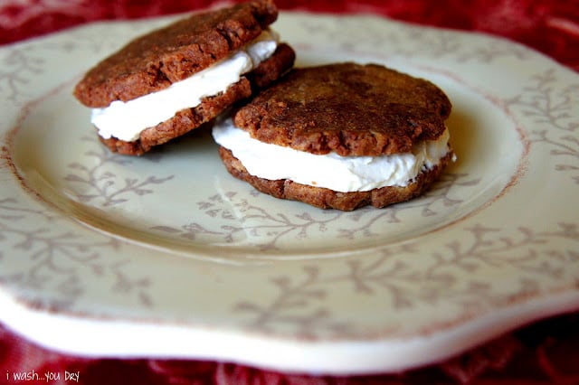 Two cookie sandwiches displayed on a plate