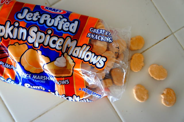 An open bag of Pumpkin Spiced Mallows with pumpkin shaped marshmallows spilling out