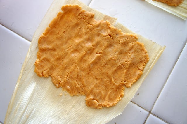 The tamale paste pressed into a corn husk