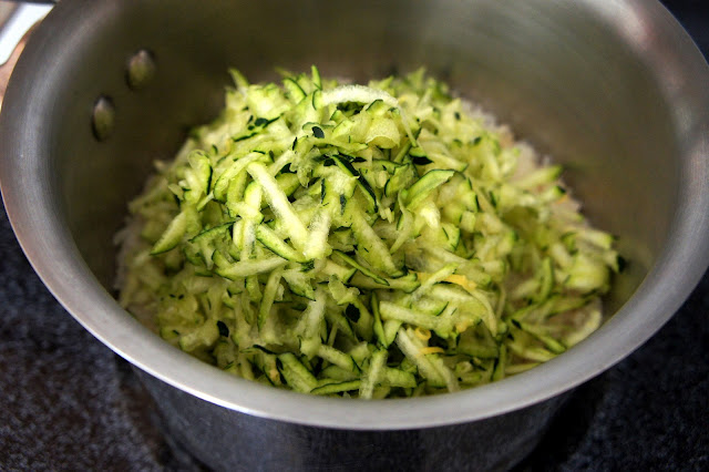 Shredded zucchini added to a pot of rice