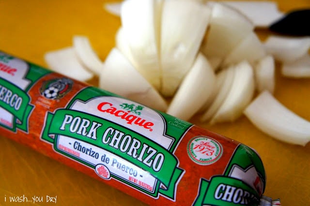 A package of Pork Chorizo next to chopped onions