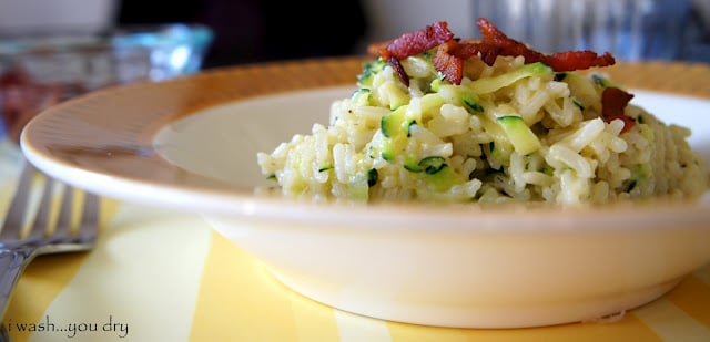 A close up of a bowl of Cheesy Zucchini Rice with Bacon on top