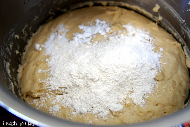 A close up of dough in a pot after it has been rising