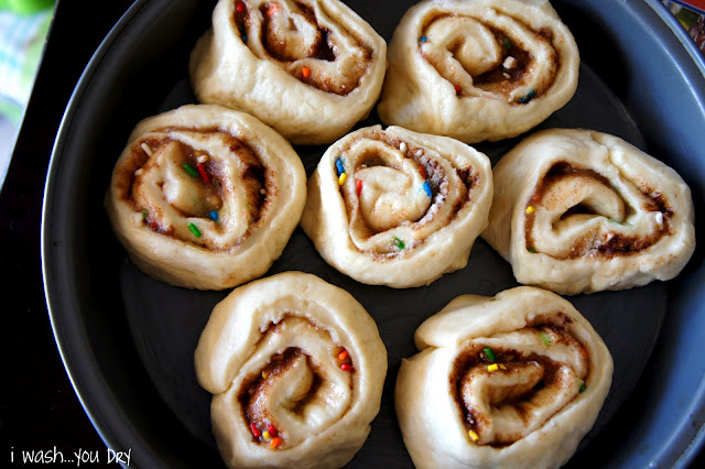 A close up of a pan filled with raw cinnamon rolls ready for baking 