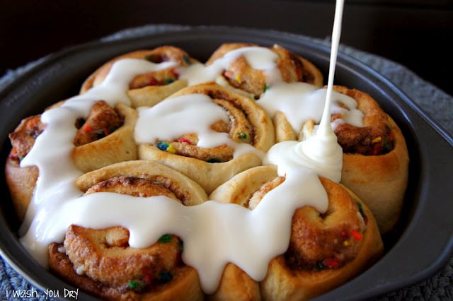 A pan of cinnamon rolls, topped with icing