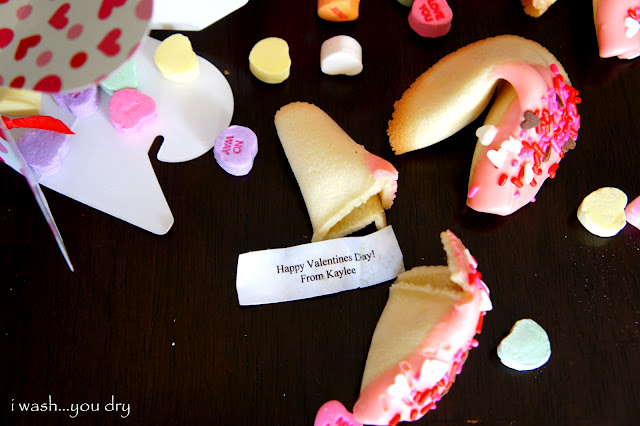 A homemade fortune cookie broken in half showing the paper message from inside