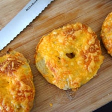 A close up of Jalapeño Cheddar Bagels on a cutting board