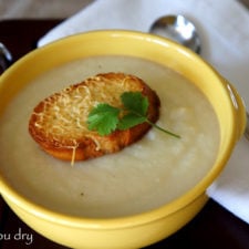 A bowl of soup with a Asiago Crouton on top
