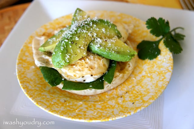 A close up of a plate with an Open Faced Egg and Avocado Sandwich on it