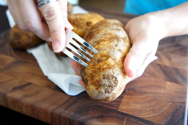 Use a fork to pierce the skins of the potatoes.