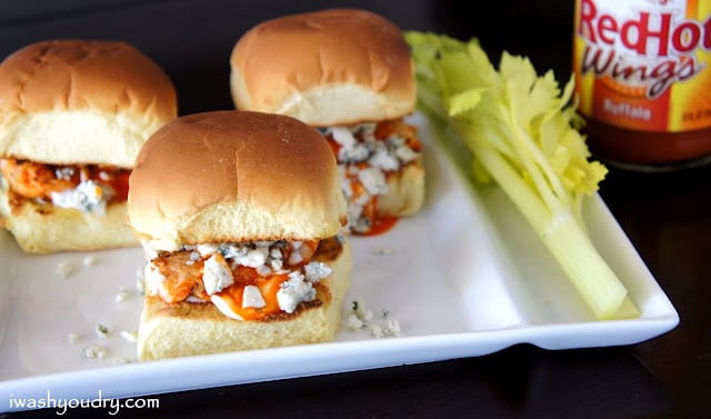 A close upon sliders on a plate filled with buffalo chicken and blue cheese