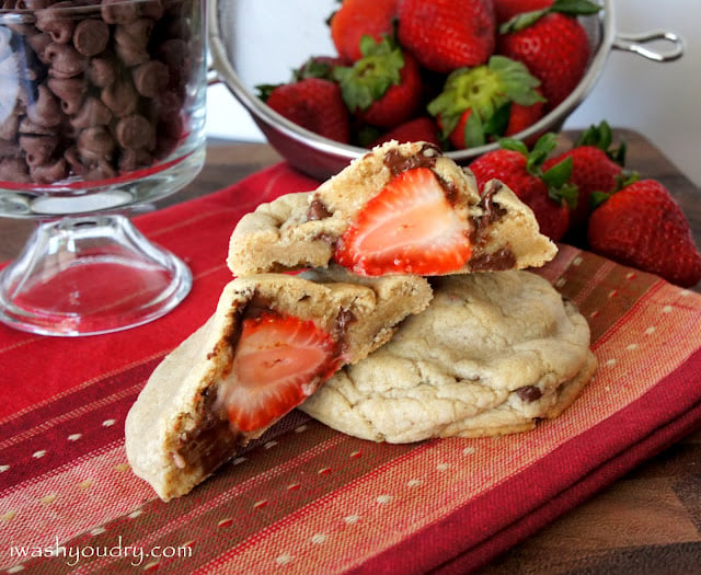 A close up look of a Strawberry stuffed Chocolate Chip Cinnamon Cookie split in half to showcase the stuffed strawberry