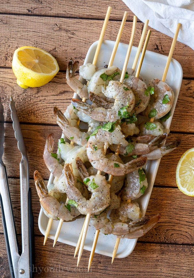 Thread the shrimp through the skewers so they can lay flat on the grill and easily be flipped.