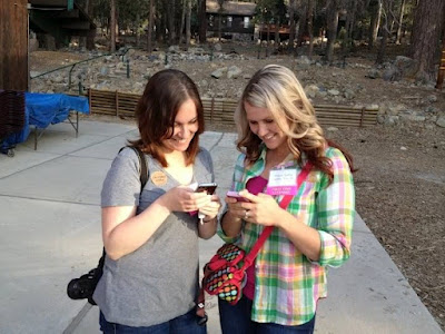 Shawn from I Wash You Dry at Camp Blogaway 2012 pictured with a friend, both looking at their phones