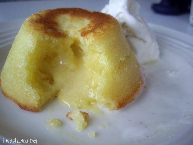 A close up of a a White chocolate Lemon Lava Cake broken open to expose the oozing center. 