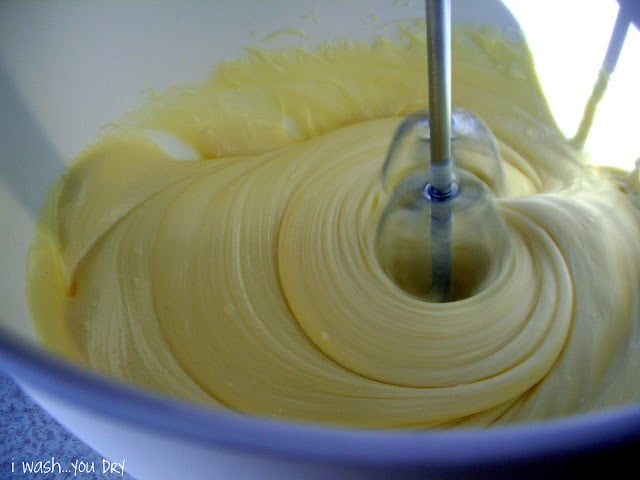 A close up of batter being mixed in a bowl. 