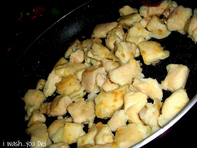 Chopped chicken cooking in a skillet. 