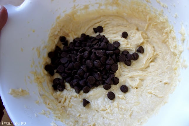 A close up of batter in a bowl with chocolate chips.