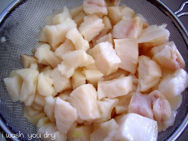 Diced cook fish in a strainer. 