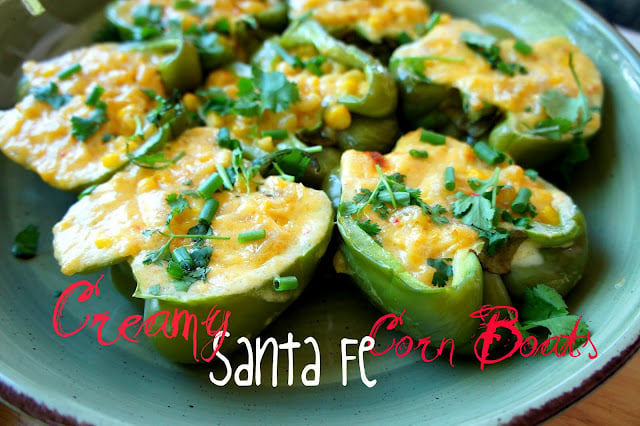 Pepper halves displayed on a plate, stuffed with a corn mix titled, \"Creamy Santa Fe Corn Boats\"