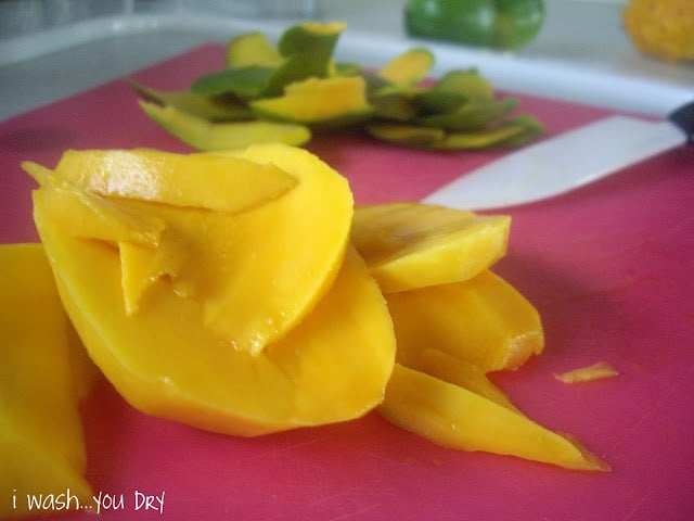 Sliced mango on a cutting board.