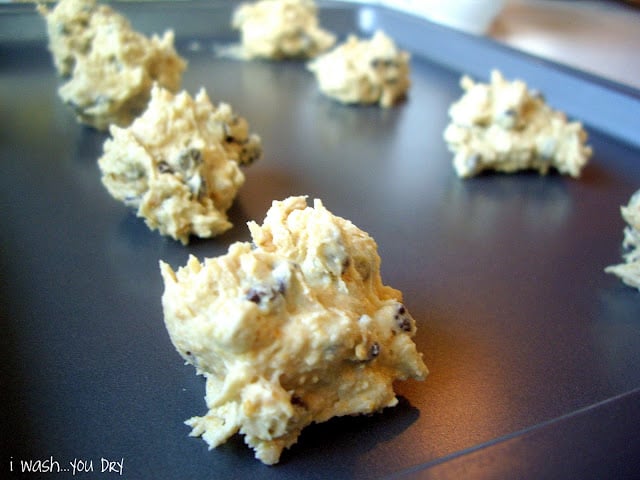 Balls of cookie dough added to a baking sheet. 