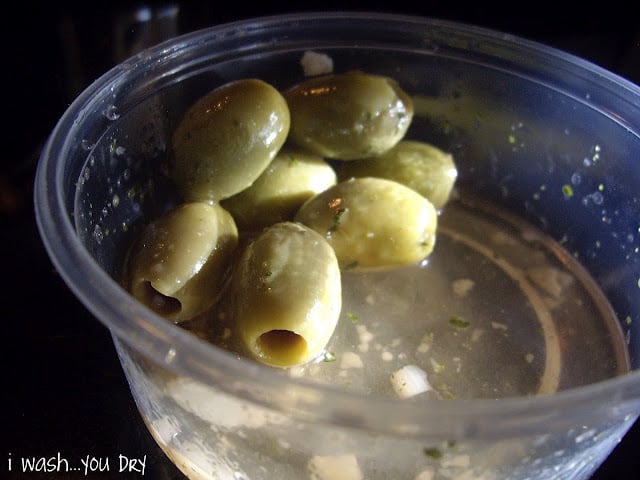 Olives in a plastic dish.