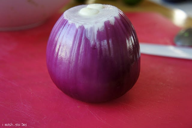 A close up of an onion on a cutting board. 