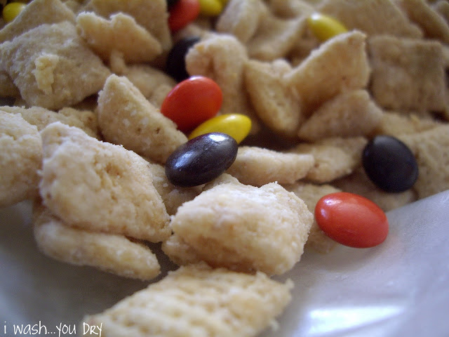 A close up of cereal and Reeses Pieces. 