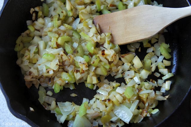 Chopped veggies sautéing in a pan.