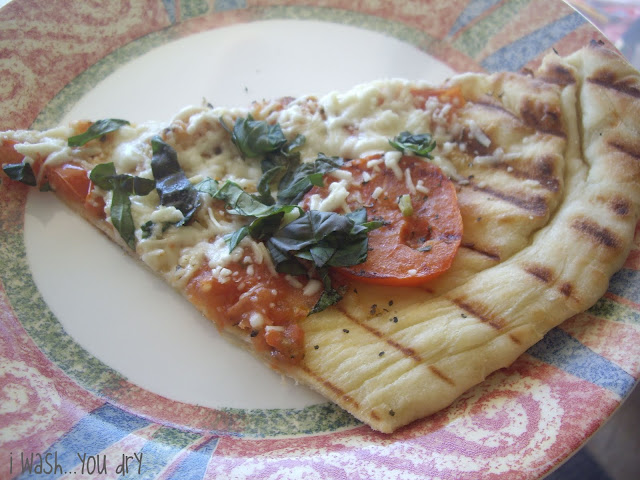A slice of Margherita pizza on a plate. 