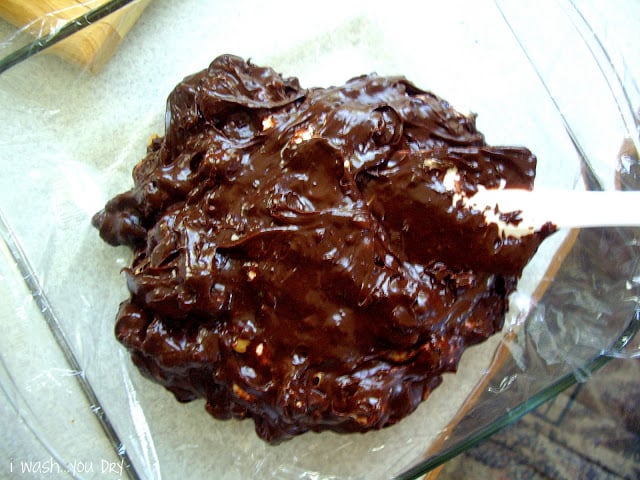 Fudge mixture poured into a plastic lined glass dish.