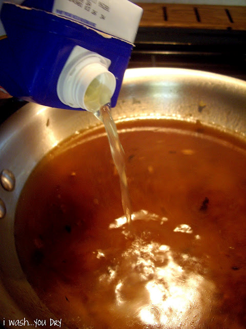 Chicken stock being added to the pan.