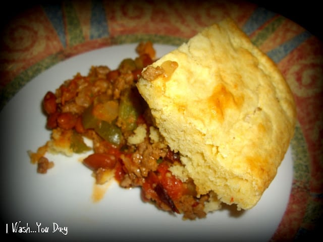 A plate of food: meat mixture topped with breading