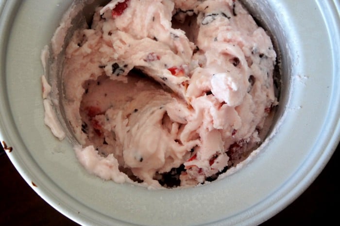 A close up of an ice cream maker with freshly made Dark Chocolate Covered Cherry Frozen Yogurt