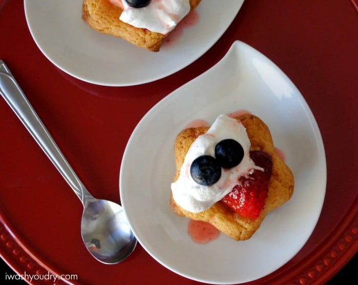 Strawberry Shortcake Cookies topped with whipped cream displayed on a plate.